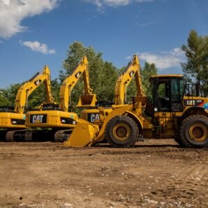 Four yellow excavators at an outdoor construction site in Kyiv, Ukraine.